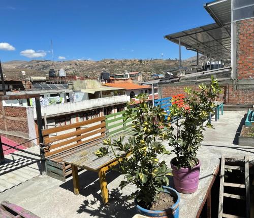 a wooden bench sitting on top of a roof at Big Mountain Hostel in Huaraz