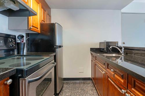 a kitchen with a sink and a stove top oven at Best Western Plus Sands in Vancouver