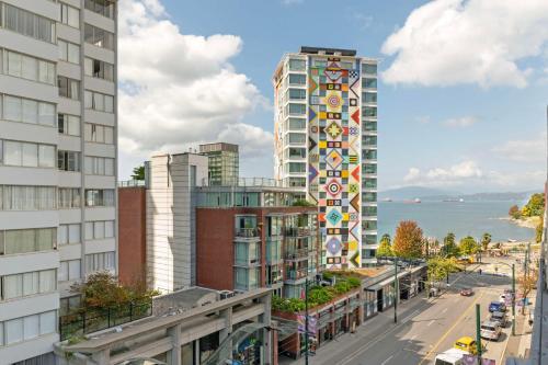 a city street with tall buildings and the ocean at Best Western Plus Sands in Vancouver