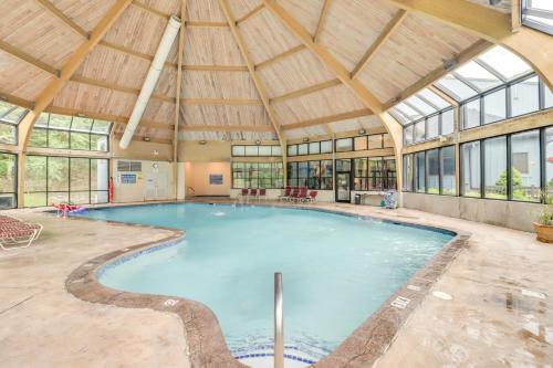 an indoor swimming pool with a large building with windows at Community Indoor Pool Tannersville Townhome in Tannersville