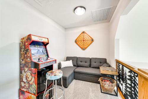 a living room with a couch and a video game at Brand-New Perry House with Kayaks and Lake Access in Perry
