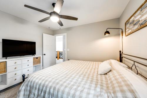 a bedroom with a bed and a flat screen tv at Brand-New Perry House with Kayaks and Lake Access in Perry