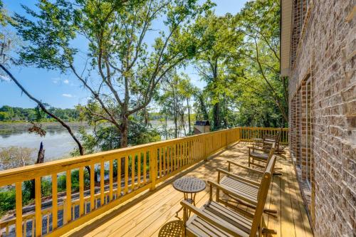 a wooden deck with benches and a view of a river at Brand-New Perry House with Kayaks and Lake Access in Perry