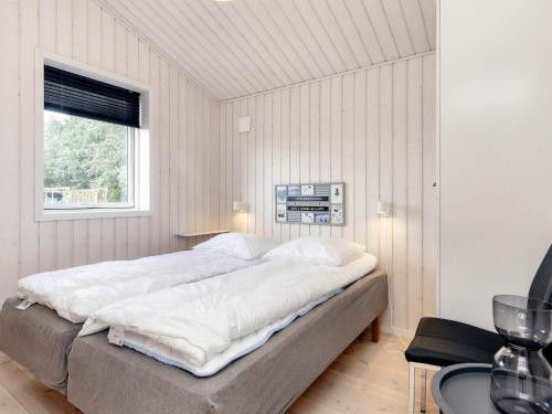 een groot bed in een slaapkamer met een raam bij 4 star holiday home in Væggerløse-By Traum in Bøtø By
