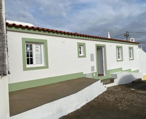 a white house with green and white walls at Casa Primavera in Alcoutim