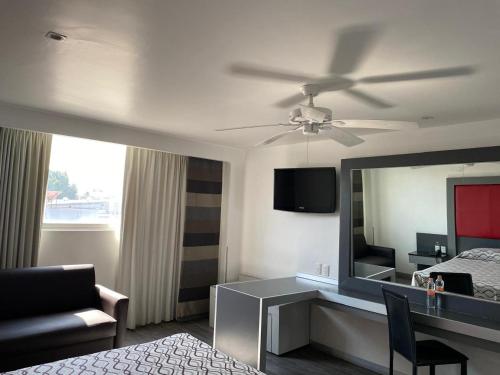 a hotel room with a bed and a mirror at Hotel Atenas Plaza in Mexico City