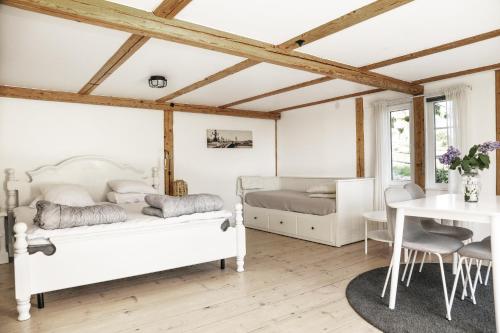 a bedroom with two beds and a table and chairs at Skärgårdslägenhet med havsutsikt i Sankt Anna! NR1 in Sankt Anna