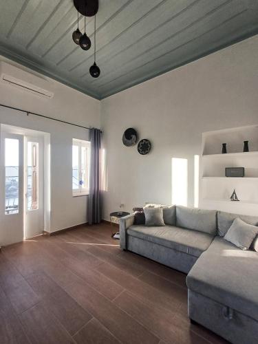 a living room with a couch and a table at Duchess Harbour View in Symi