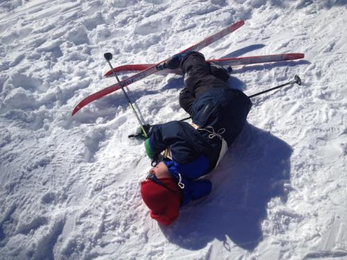 uma pessoa está deitada na neve em esquis em Storliens Fjällgård em Storlien