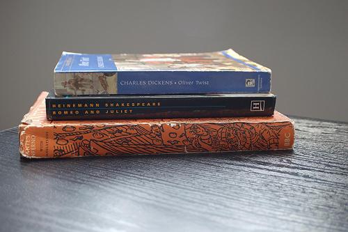three books stacked on top of each other on a table at Dreamstay Apartments London Garden Central Tube Olympic in London