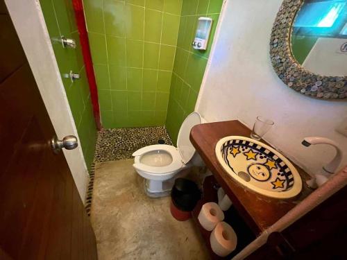 a bathroom with a sink and a toilet at XpuHa Bonanza in Xpu Ha