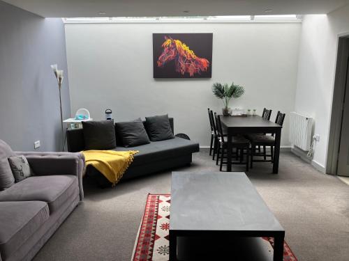 a living room with a couch and a table at Lancing Apartments - Spacious 2 Bed - Sleeps 6 - Burnham Village in Slough