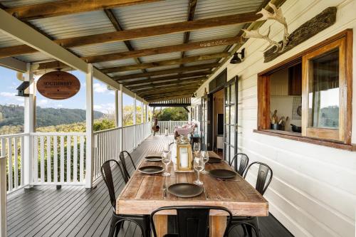 a table on the porch of a house at Beam Creek Cottage - Montville in Montville