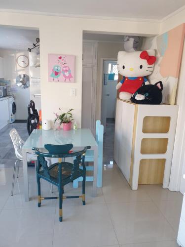 a kitchen with a table and a cat on the counter at C2 Save money budget affordable cabin with comfort! - Cabin2 in Auckland