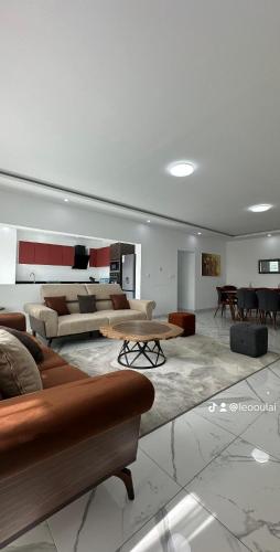 a large living room with couches and a table at Residence Roume Abidjan Plateau in Abidjan