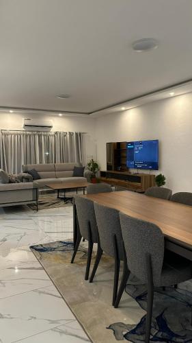 a living room with a large wooden table and chairs at Residence Roume Abidjan Plateau in Abidjan