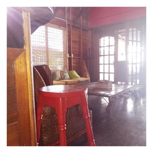 a living room with a red table and a couch at Villa Bahia Del Sol in Bocas del Toro
