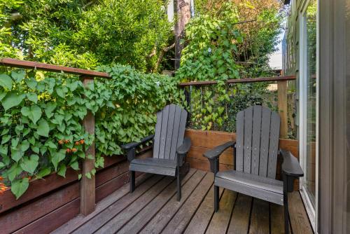 two chairs sitting on a deck with a garden at Wheeler on the Bay Lodge and Marina in Wheeler