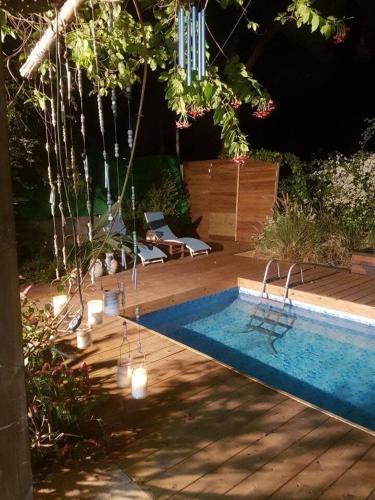 a swimming pool in a yard with lights next to it at Super nice villa with pool 10 min from Natania in Kfar Yona