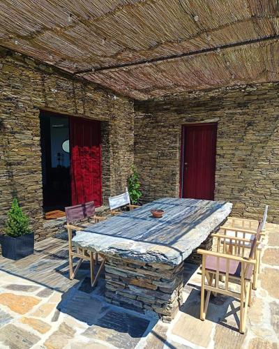 a wooden table and chairs on a patio at Quinta do Fraguil - Douro Valley in Valença do Douro
