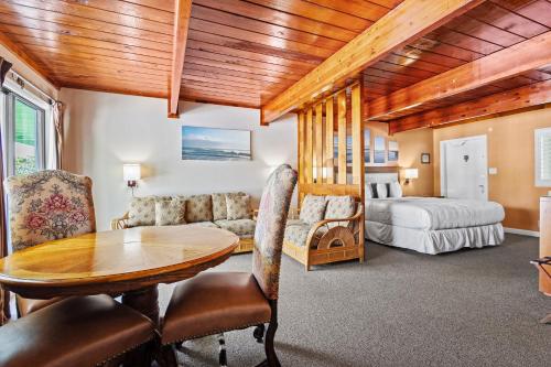 a living room with a table and a bed at Fort Pierce Oceanfront Inn- Suite- King Bed #6 in Fort Pierce
