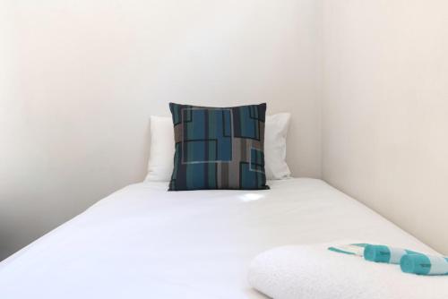 a bed with a pillow on top of it at Echo Holiday Parks - Windsor Gardens in Adelaide