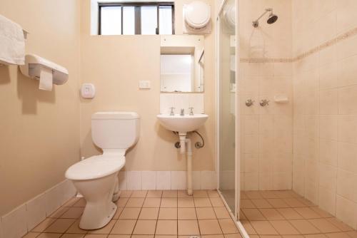 a bathroom with a toilet and a sink at Echo Holiday Parks - Windsor Gardens in Adelaide