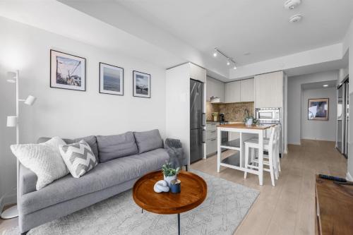 a living room with a couch and a table at RentX Downtown 2-Bed Suite Gym WiFi in Toronto