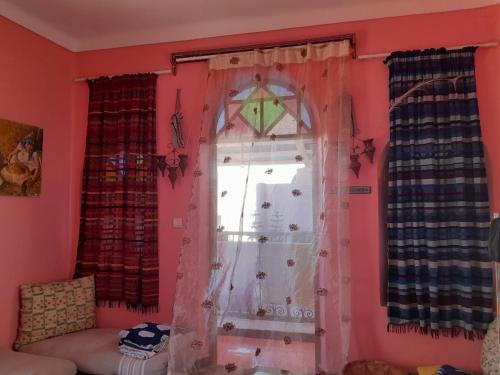 a room with a window with a kite on the wall at Dar Sam - Red Room in Rabat