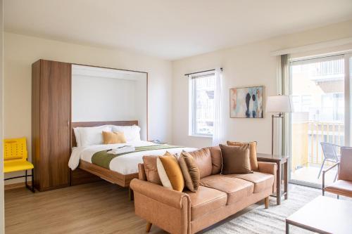 a bedroom with a bed and a couch at Walker's Point Studio with Gym and Balcony in Milwaukee