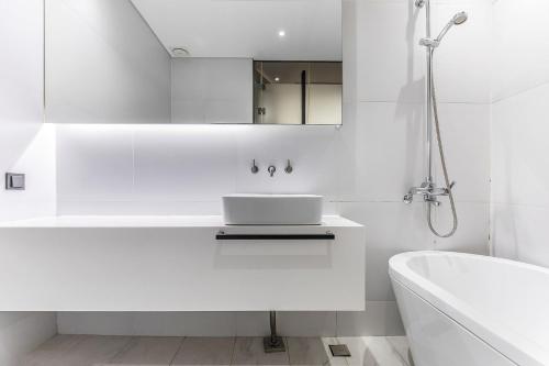a white bathroom with a sink and a tub at Hotel The Designers Cheongnyangni in Seoul