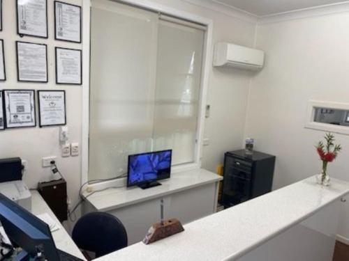 an office with a desk with a computer on a window at Buckaroo Motor Inn in Warwick