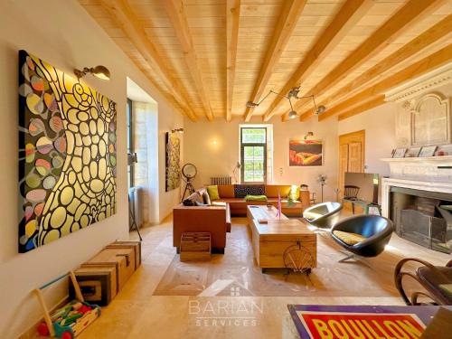 a living room with a couch and a fireplace at Le Domaine de Stian in Nuaillé-dʼAunis