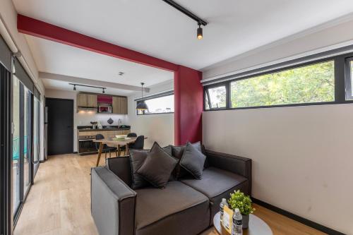 a living room with a couch and a table at Capitalia Condesa Escandon in Mexico City