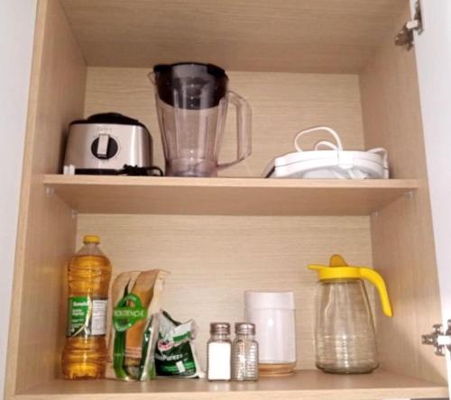 a cupboard with a blender and other kitchen items at AH/Loft vista natural, Coworking, Terraza, Usaquén in Bogotá