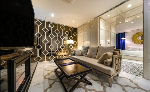 a living room with a couch and a television at Hotel The Designers Cheongnyangni in Seoul