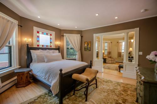 a bedroom with a bed and a living room at 254 South Union Street Guest House in Burlington