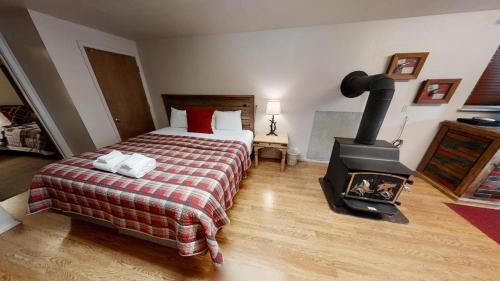 a bedroom with a bed and a wood stove at Pet Friendly - WiFi - Washer - Dryer - Fireplace - Grill in Red River