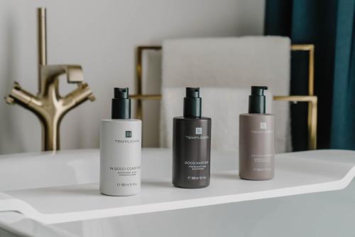 three bottles ofodorizers sitting on a white shelf at The Halyard Liverpool, Vignette Collection by IHG in Liverpool