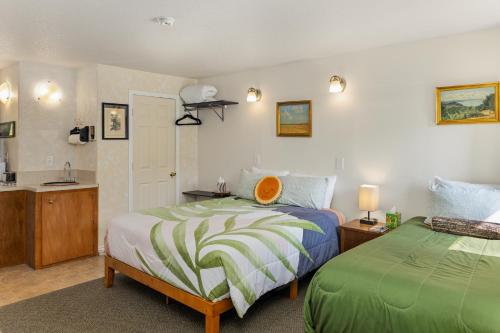 a bedroom with two beds and a sink in it at Wheeler on the Bay Lodge and Marina in Wheeler