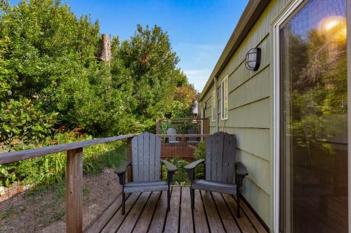 a porch with two benches on a deck at Wheeler on the Bay Lodge and Marina in Wheeler