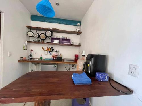 a kitchen with a wooden table with a blue frisbee at XpuHa Bonanza in Xpu Ha