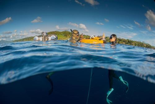 a group of people laying on a raft in the water at BougainVilla Savusavu in Savusavu
