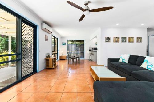 a living room with a couch and a ceiling fan at Beaches in Toogoom