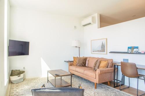 a living room with a couch and a table at Modern East Side 1BR Apt with Balcony, Pool, and Gym in Milwaukee