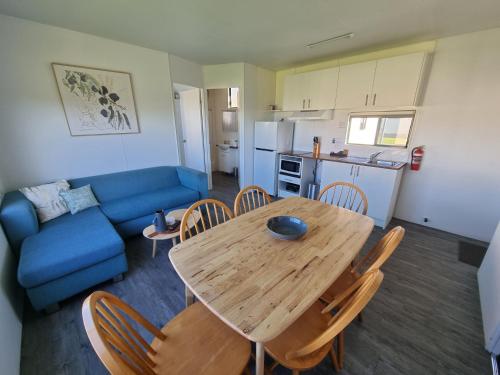 a living room with a table and chairs and a couch at Swansea Holiday Park Tasmania in Swansea