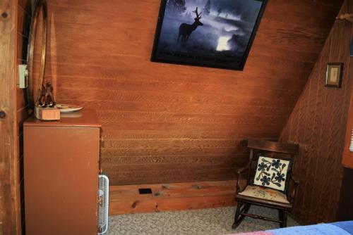 a room with a refrigerator and a picture on the wall at Claim Jumper A-Frame 1 - On The River - Pet Friendly - WiFi - Cable - Wood Burning Fireplace in Red River