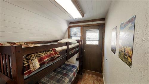 a room with two bunk beds and a window at Claim Jumper A-Frame 2 - On The River - WiFi - Cable - Wood Burning Fireplace in Red River