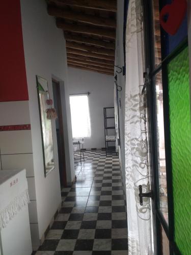 a hallway with a room with a checkered floor at Casas de Epoca -Limerencia in Charbonier