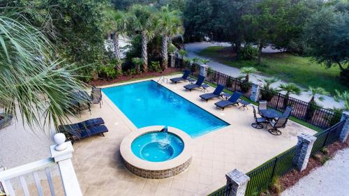 an overhead view of a swimming pool with chairs at Tolater in DeBordieu Colony home by Peace Vacations in Georgetown